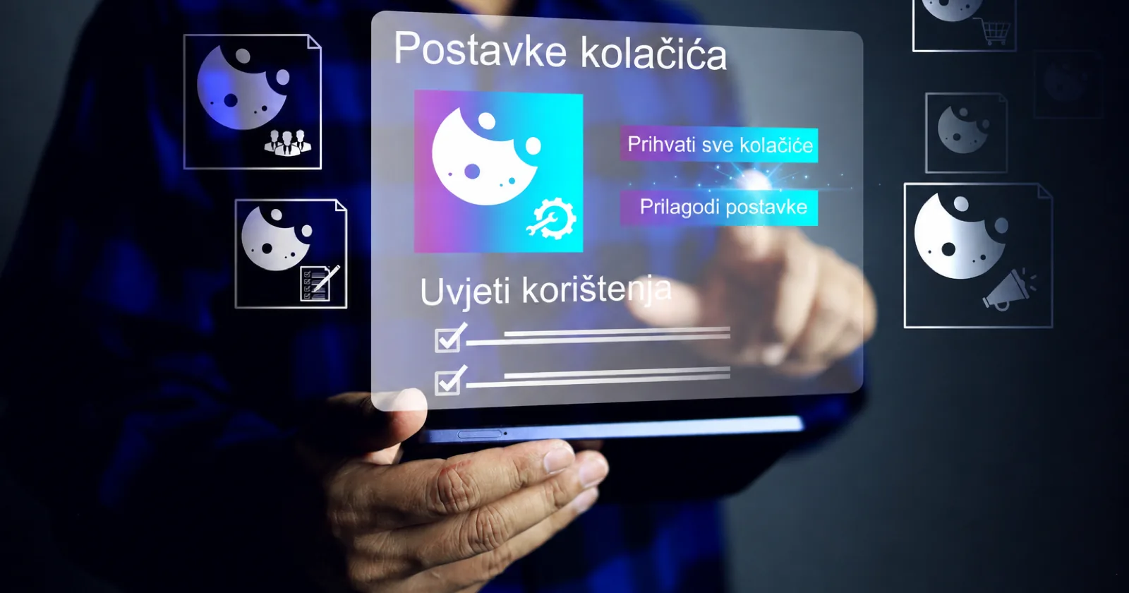 Osoba drži tablet s prikazom postavki kolačića i gumbima za pristanak